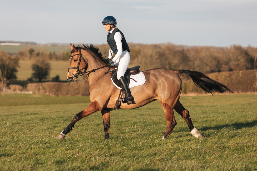 Jemima Howden cross country schooling in the MotionAir hybrid air jacket on a bay horse